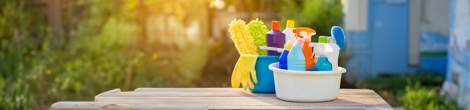 A table with cleaning supplies and gloves on it.