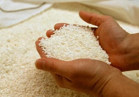 A person holding rice in their hands